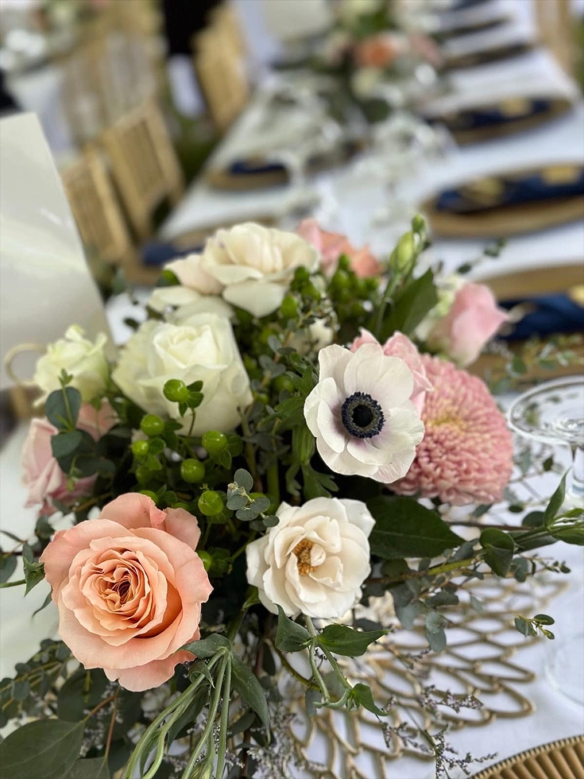 Blush, ivory, and green centerpiece at an elegant wedding reception