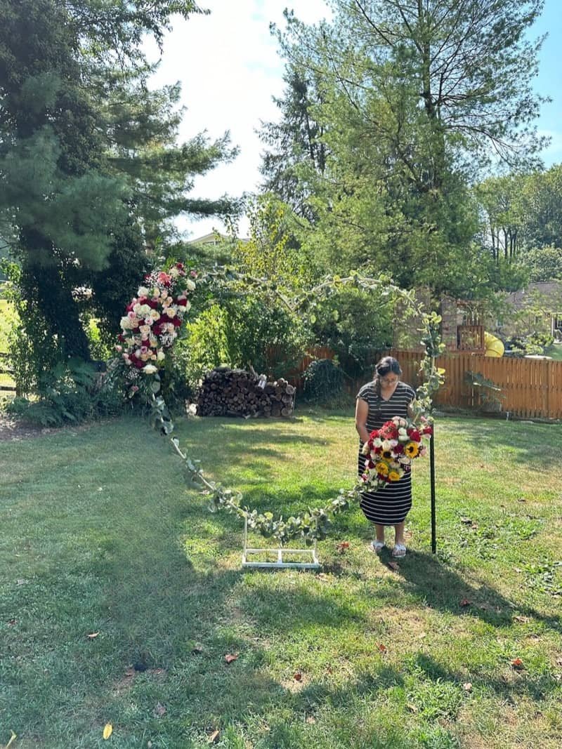Circular floral arch installation in a garden setting