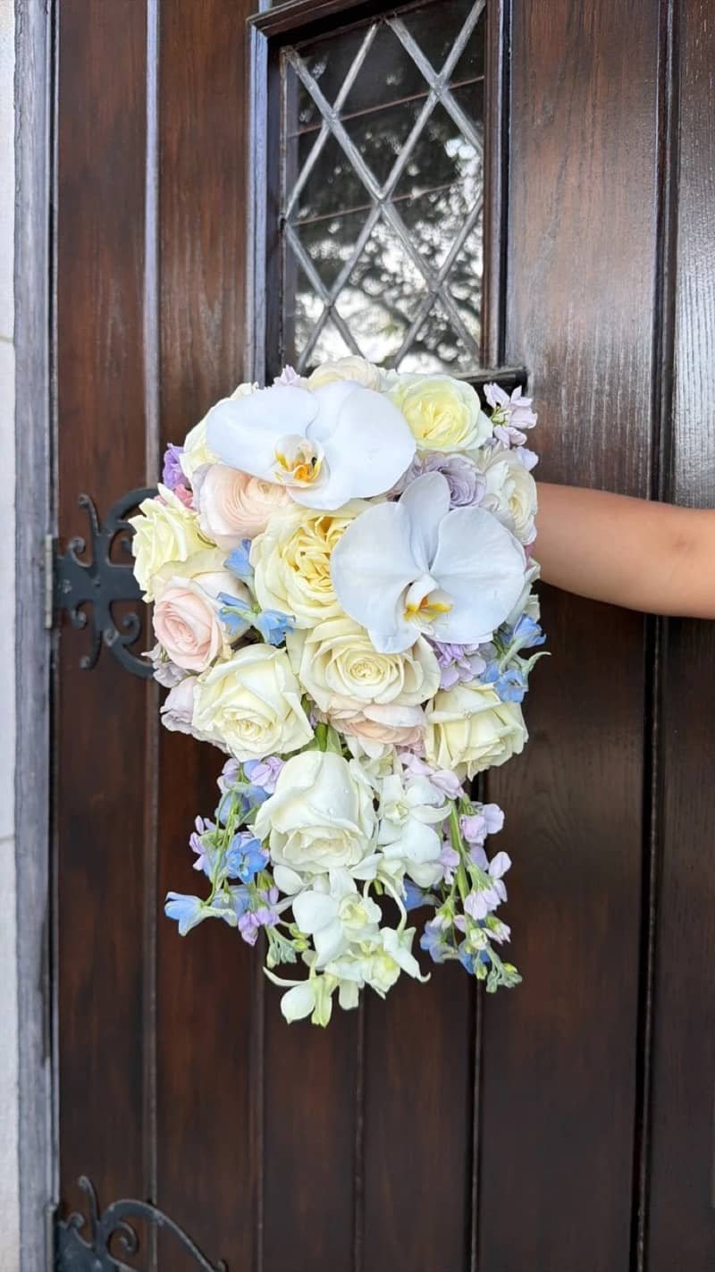 Cascading bridal bouquet of orchids and roses