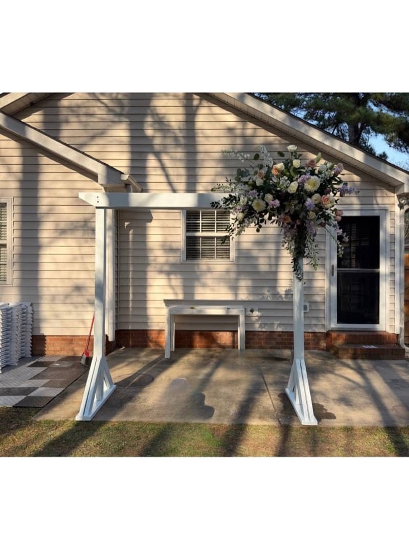 White wooden wedding arch with floral arrangement